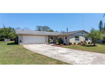 Charming single-story home featuring a spacious driveway, well-maintained lawn, and mature landscaping at 1021 Mare Bello Dr, Winter Park, FL 32792