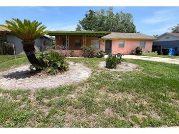 Charming single-story home featuring a covered porch and unique landscaping in the front yard at 4845 Elese St, Orlando, FL 32811