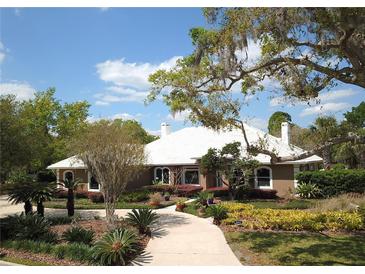 Charming single-story home with manicured front yard and mature trees at 8905 South Bay Dr, Orlando, FL 32819