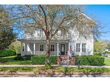 Charming two-story home features a welcoming front porch and a beautifully landscaped front yard at 2090 Common Way Rd, Orlando, FL 32814