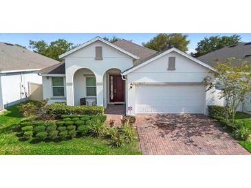 Charming single-story home with well-maintained landscaping, brick driveway, and inviting front entrance at 2145 Rush Bay Way, Orlando, FL 32824