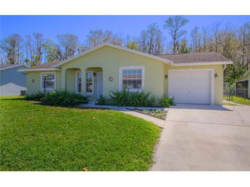 Charming single-story home featuring a well-manicured lawn, a one car garage, and a welcoming front porch at 260 La Paz Dr, Kissimmee, FL 34743