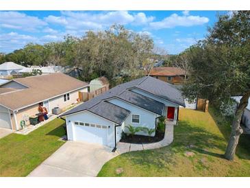 Charming single-Gathering home features a well-maintained lawn, a paved walkway, and a one-car garage at 3106 Garden Ct, St Cloud, FL 34769