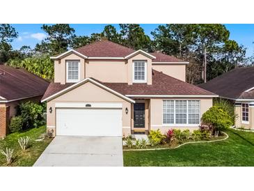 Charming two-story home with a well-manicured lawn and inviting curb appeal in a peaceful neighborhood at 3121 Bellingham Dr, Orlando, FL 32825