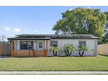 Charming single-story home with a well-manicured lawn and solar panels at 4127 Sanseviera Ln, Orlando, FL 32822