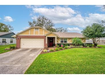 Charming single-Gathering home featuring well-manicured landscaping and a brick-accented facade with attached garage at 4442 Glenview Ln, Winter Park, FL 32792