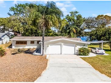 Charming home featuring a two-car garage, a well-manicured lawn, and a stylish carport at 801 Springview Dr, Orlando, FL 32803