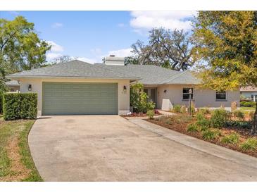 Charming single-story home with a two-car garage and beautifully landscaped front yard at 111 Woodstream Ct, Maitland, FL 32751