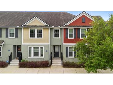 Charming townhome with colorful facade, neat landscaping, and inviting entrance at 1341 Mill Stream Ln, Winter Springs, FL 32708