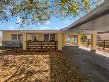 Charming single-story home featuring a covered front porch and carport at 411 Thomas Ave, Frostproof, FL 33843