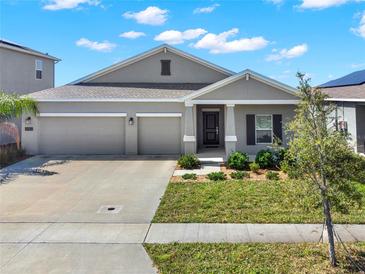 Charming home with a well-manicured lawn, two-car garage, and inviting front porch at 4180 Bull St, St Cloud, FL 34772
