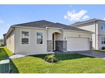 Charming single-story home featuring stone accents and a well-manicured lawn at 1232 Celery Oaks Ln, Sanford, FL 32771