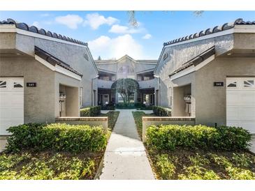 Inviting exterior view of townhomes showcasing tidy landscaping and a pathway to the main entrance at 139 Durham Pl, Longwood, FL 32779