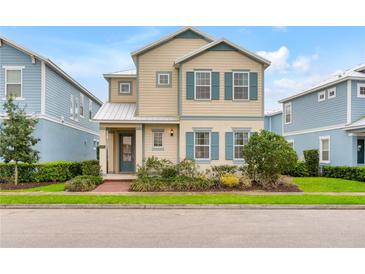 Charming two-story home with blue shutters, beige siding, and a well-maintained front lawn at 1468 Fairview Cir, Reunion, FL 34747