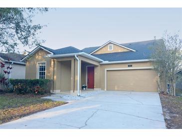 Charming single-story home featuring a well-maintained lawn, covered entry, and two-car garage at 4852 Blue Major Dr, Windermere, FL 34786