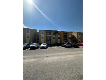 Condo's exterior features ample parking and convenient access to building amenities at 5271 Images Cir # 303, Kissimmee, FL 34746