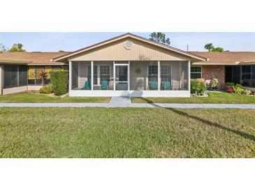 Charming villa with a cozy screened-in porch and manicured front lawn at 1001 Plantation Dr # D5, Kissimmee, FL 34741