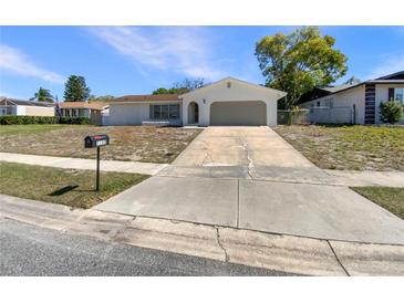 Charming single-story home with a well-maintained lawn and an inviting front entrance at 1155 Galahad Dr, Casselberry, FL 32707