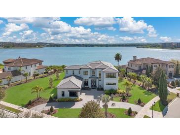 Stunning lakefront estate with lush landscaping and modern architectural details at 17300 Pesce Loop, Montverde, FL 34756