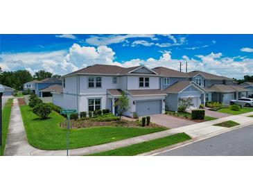 Charming two-story home with a two-car garage, brick paver driveway, and nicely landscaped yard at 2313 Ivy Harvest Pl, Oviedo, FL 32765