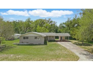 Charming single-story home featuring a well-maintained lawn, carport, and welcoming facade at 2502 Falkner Rd, Orlando, FL 32810