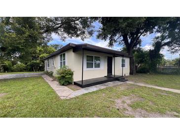 Charming single-story home with a cozy front porch and mature trees providing ample shade at 3440 S Nashville Ave, Orlando, FL 32839