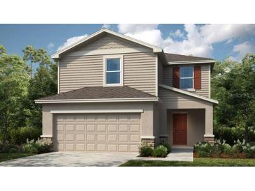 Charming two-story home with neutral siding, a two-car garage, and simple landscaping at 386 Wayland Dr, Haines City, FL 33844