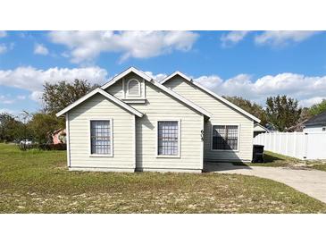 Charming single-story home with a quaint front facade and well-maintained lawn at 605 Swallow Ct, Apopka, FL 32712
