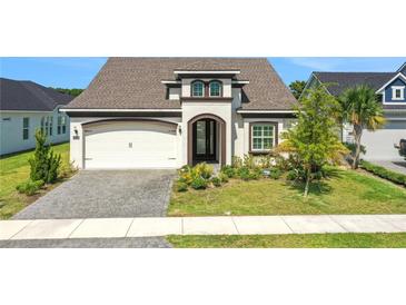 Charming single-Gathering home featuring a well-manicured lawn and attached two-car garage at 6239 Woodhaven Village Dr, Port Orange, FL 32128