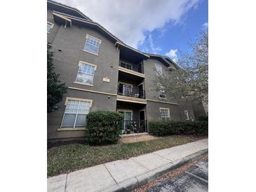 Multi-story condo building with balconies and well-maintained landscaping at 102 Vista Verdi Cir # 220, Lake Mary, FL 32746