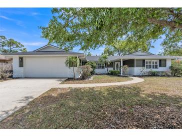 Charming single-story home boasts a two-car garage, fresh exterior paint, and mature landscaping at 116 E Cottesmore Cir, Longwood, FL 32779