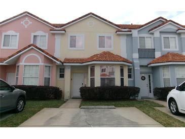 Charming multi-colored townhomes feature tile roofs and well-maintained landscaping, creating curb appeal at 1285 S South Beach Circle Cir, Kissimmee, FL 34746