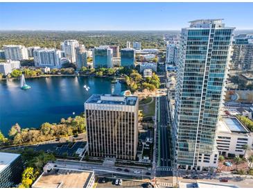 Stunning aerial view featuring a high rise condo, lake, and downtown cityscape at 150 E Robinson St # 1007, Orlando, FL 32801