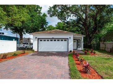 Charming single-story home with a brick driveway and beautifully landscaped front yard at 1505 25Th St, Orlando, FL 32805