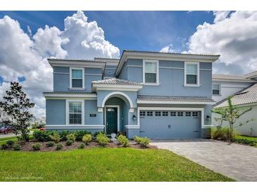 Charming two-story home featuring a well-manicured lawn and a two-car garage at 1551 Observer Ln, Davenport, FL 33896
