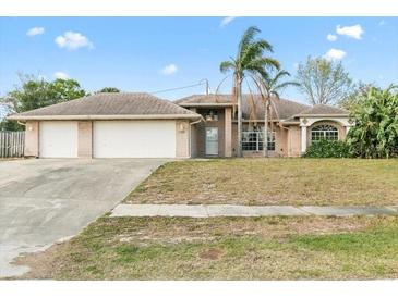 Charming single-story home with a two-car garage and a well-manicured front yard at 1960 Evard Ave, Deltona, FL 32725