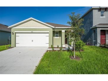 Inviting single-Gathering home with a two-car garage and freshly landscaped front yard at 2464 Ribbon Fall Ave, Davenport, FL 33837