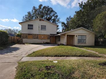 Exterior shot of a two-story home featuring a spacious front yard and long driveway at 2652 Ravenall Ave, Orlando, FL 32811