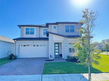 Beautiful two-story home with a brick driveway, attached garage, and well-maintained lawn at 2861 Willowseed Ln, St Cloud, FL 34772