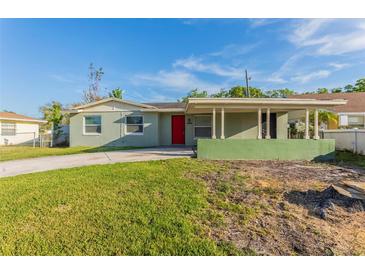 Charming single-story home with a red front door and a spacious, well-maintained lawn at 4489 Prince Hall Blvd, Orlando, FL 32811