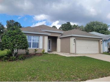 Charming single-story home boasts well-maintained landscaping and an attached two-car garage at 5523 Sw 42Nd Pl, Ocala, FL 34474