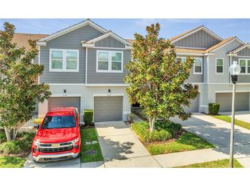 Charming townhome features a well-maintained front yard, gray siding, and attached garage in a desirable neighborhood at 9161 Shepton St, Orlando, FL 32825
