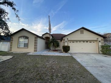 Charming single-story home with a two-car garage and well-maintained landscaping at 117 Anzio Dr, Kissimmee, FL 34758