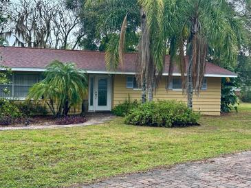 Charming single-story home with well-maintained lawn and mature trees, creating a welcoming curb appeal at 1361 Markham Woods Rd, Longwood, FL 32779