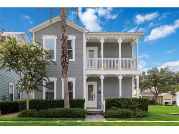 Charming two-story home featuring a double porch, well-maintained landscaping, and a welcoming facade at 1552 Fairview Cir, Reunion, FL 34747