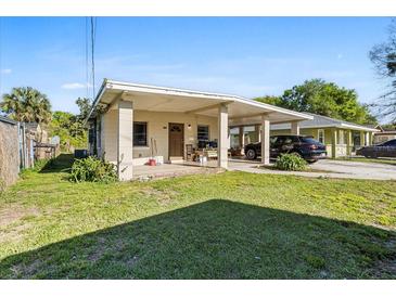 Charming single-story home with a covered carport and well-maintained front yard at 1716 2Nd Ne St, Winter Haven, FL 33881