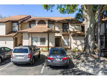Two-story townhome with parking, neutral paint, and inviting front entrance at 2900 S Semoran Blvd # 4, Orlando, FL 32822