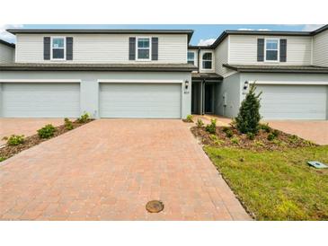 Charming two-story townhome with a brick driveway and a well-maintained front yard at 4337 Switchgrass Ln, St Cloud, FL 34772