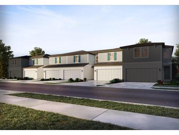 Charming two-story townhomes featuring attached garages and well-maintained front lawns at 4357 Switchgrass Ln, St Cloud, FL 34772