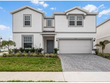 Beautiful two-story home with a manicured lawn and a gray brick driveway at 4361 Lana Ave, Davenport, FL 33897